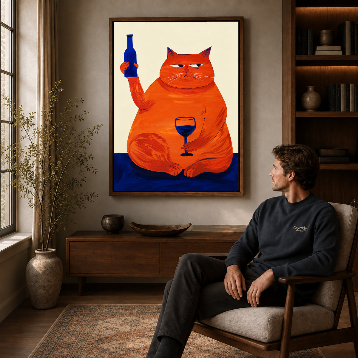 Funny Cat Canvas Art displayed in a walnut frame above wooden furniture beside a seated man.
