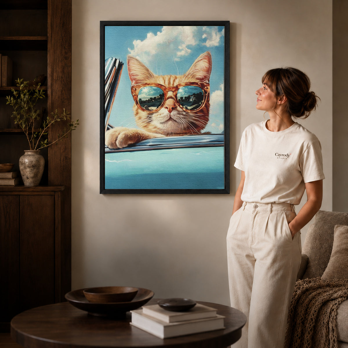 Retro Cat Canvas Art inside a black frame in a softly lit living room with books.