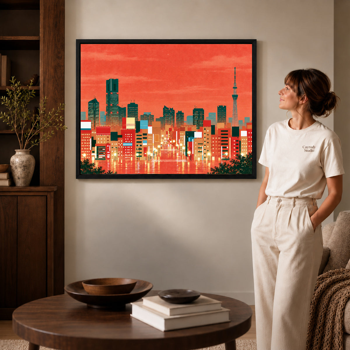 City Skyline Canvas Art inside a black frame in a softly lit living room with books.