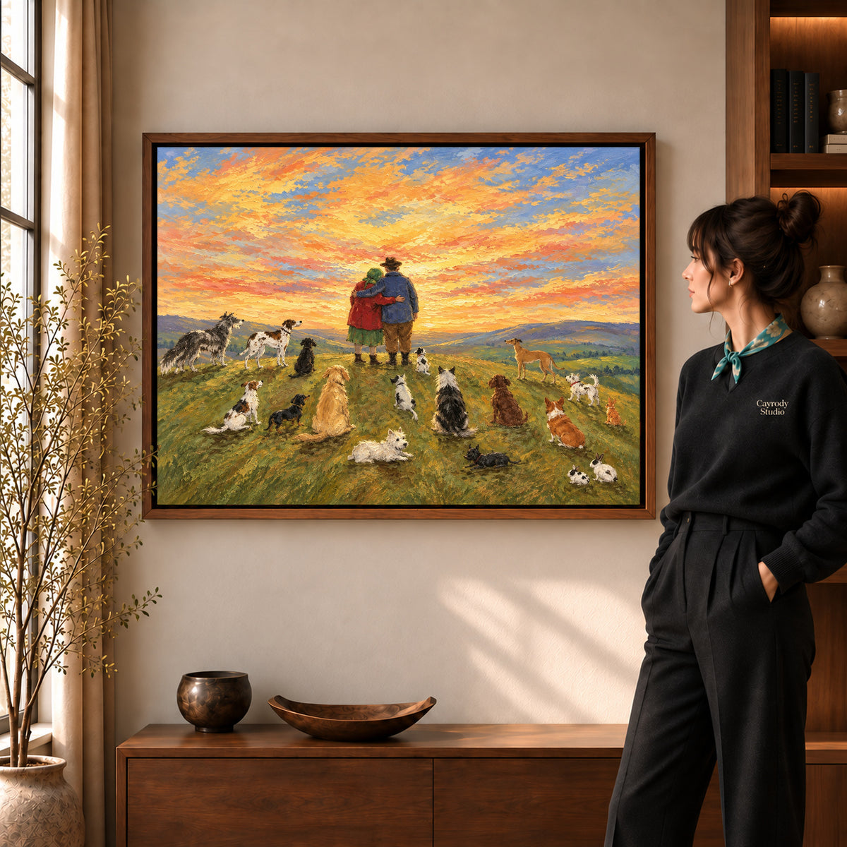 Sunset Companions Canvas Art in a walnut frame beside a standing woman and warm wooden furniture.