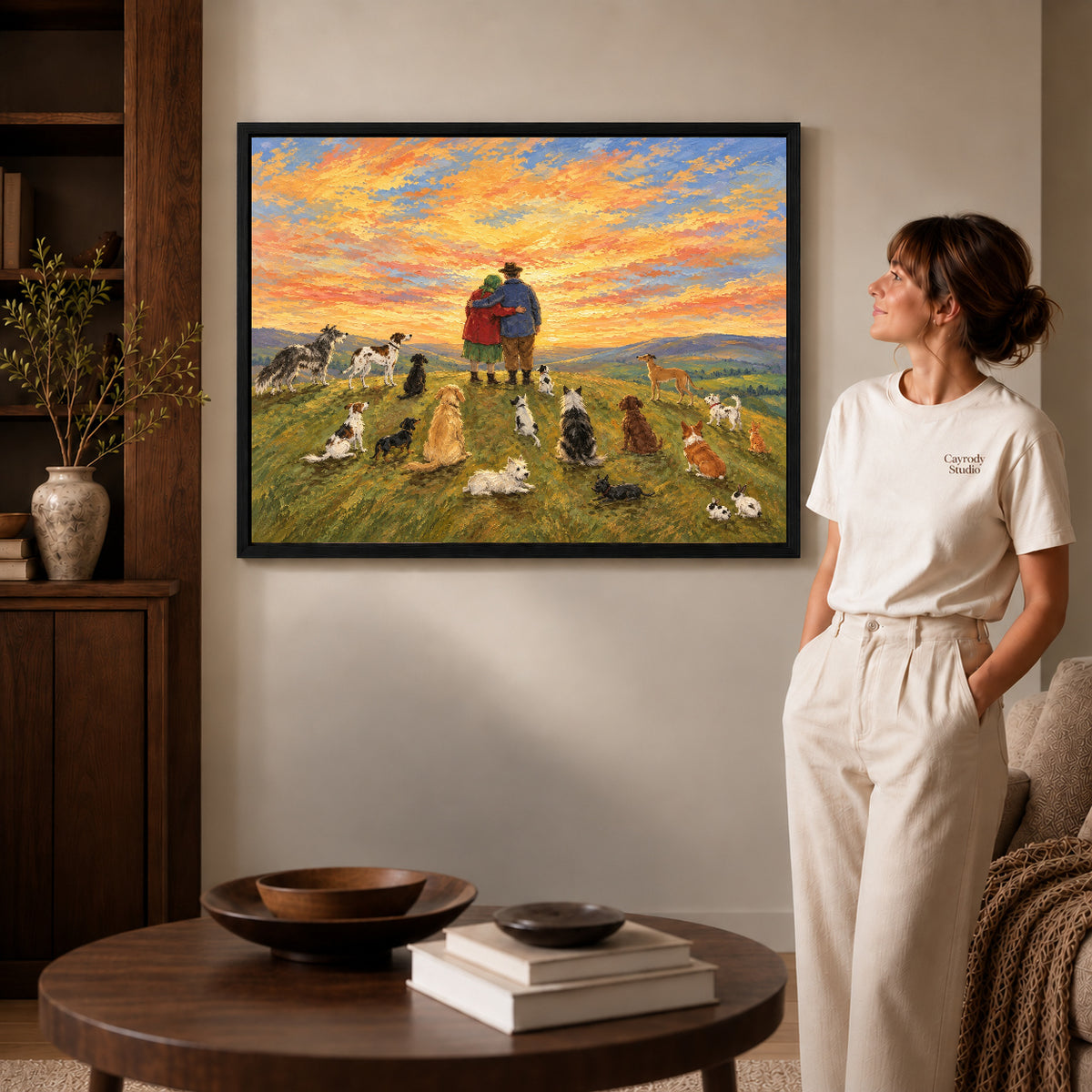 Sunset Companions Canvas Art inside a black frame in a softly lit living room with books.