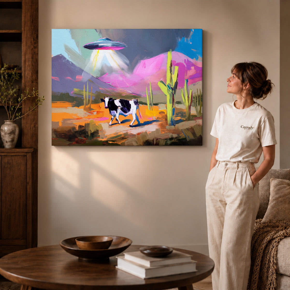 UFO Cow Canvas Art on gallery wrapped canvas with visible depth beside a woman in white.