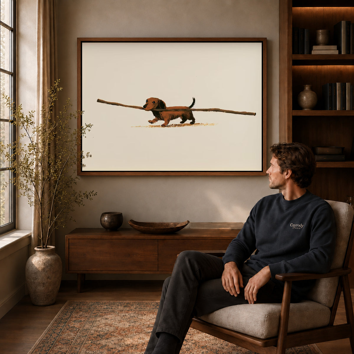 Dachshund Canvas Art displayed in a walnut frame above wooden furniture beside a seated man.