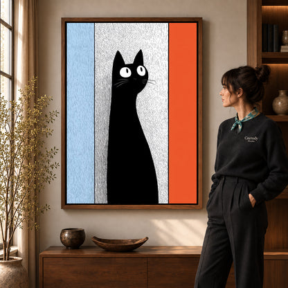 Black Cat Canvas Art in a walnut frame beside a standing woman and warm wooden furniture.