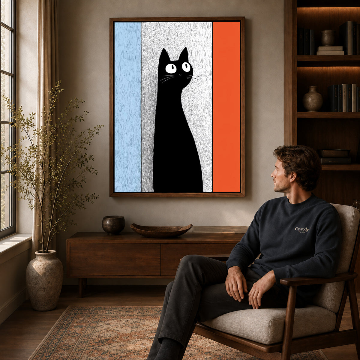 Black Cat Canvas Art displayed in a walnut frame above wooden furniture beside a seated man.