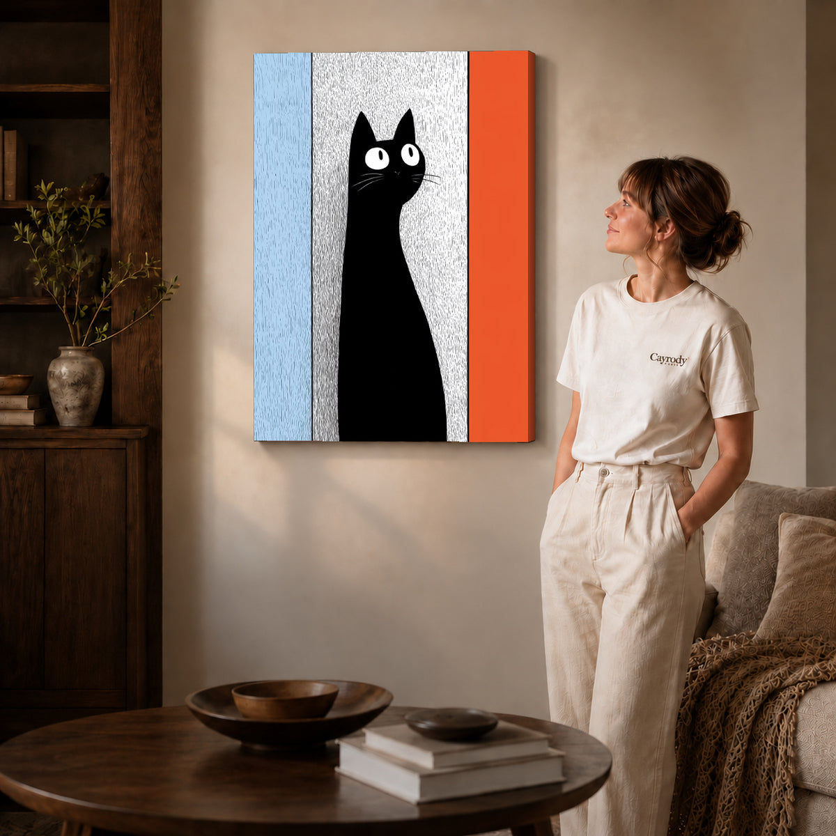 Black Cat Canvas Art on gallery wrapped canvas with visible depth beside a woman in white.