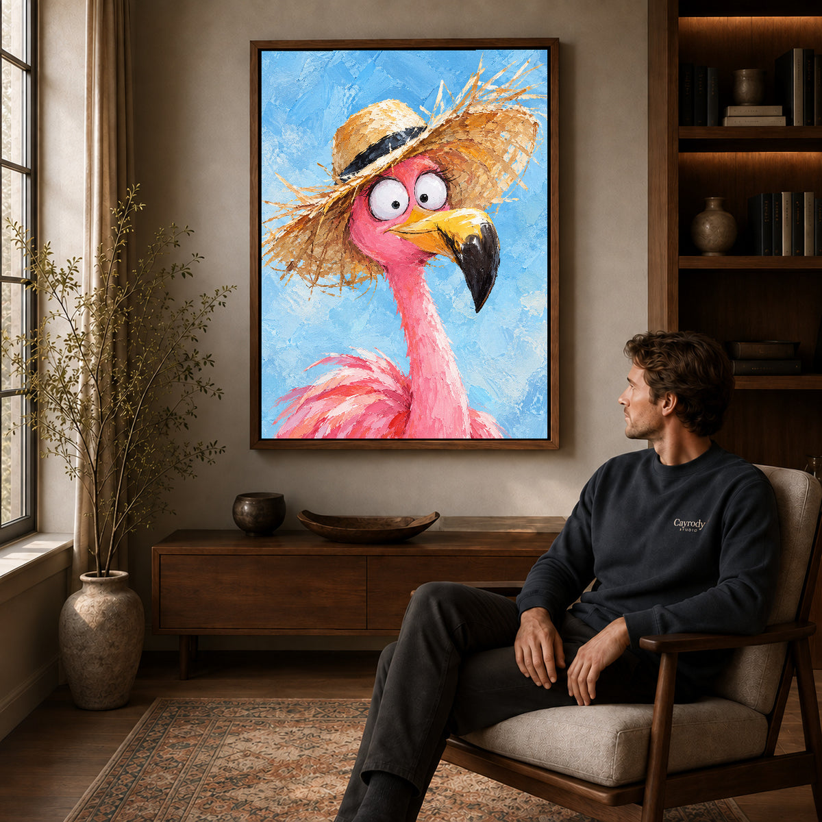 Flamingo Canvas Art displayed in a walnut frame above wooden furniture beside a seated man.
