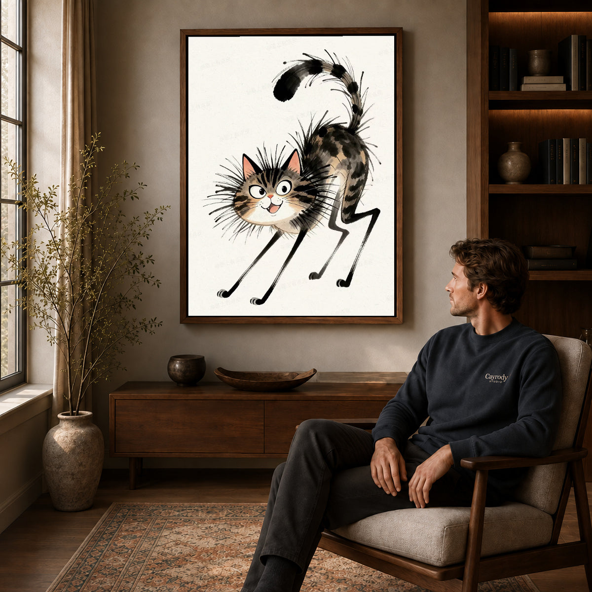 Tabby Cat Canvas Art displayed in a walnut frame above wooden furniture beside a seated man.