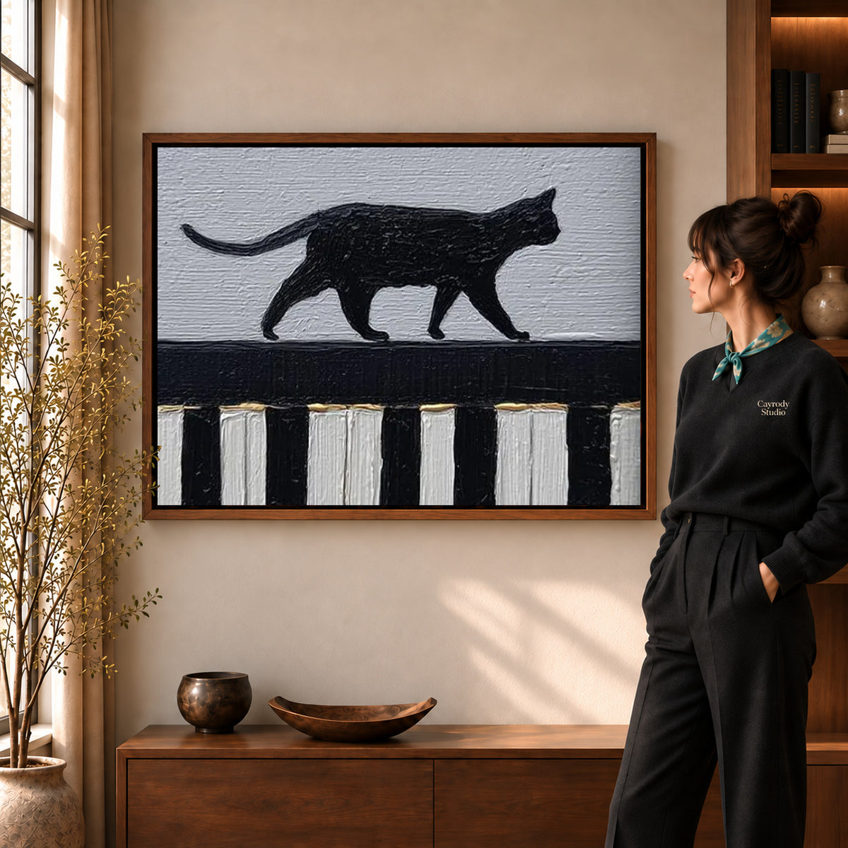 Walnut framed piano cat canvas art with the complete artwork displayed in a warm living room.