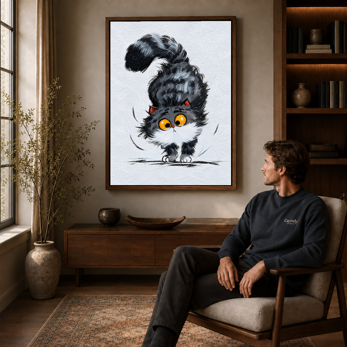 Kitten Canvas Wall Art displayed in a walnut frame above wooden furniture beside a seated man.