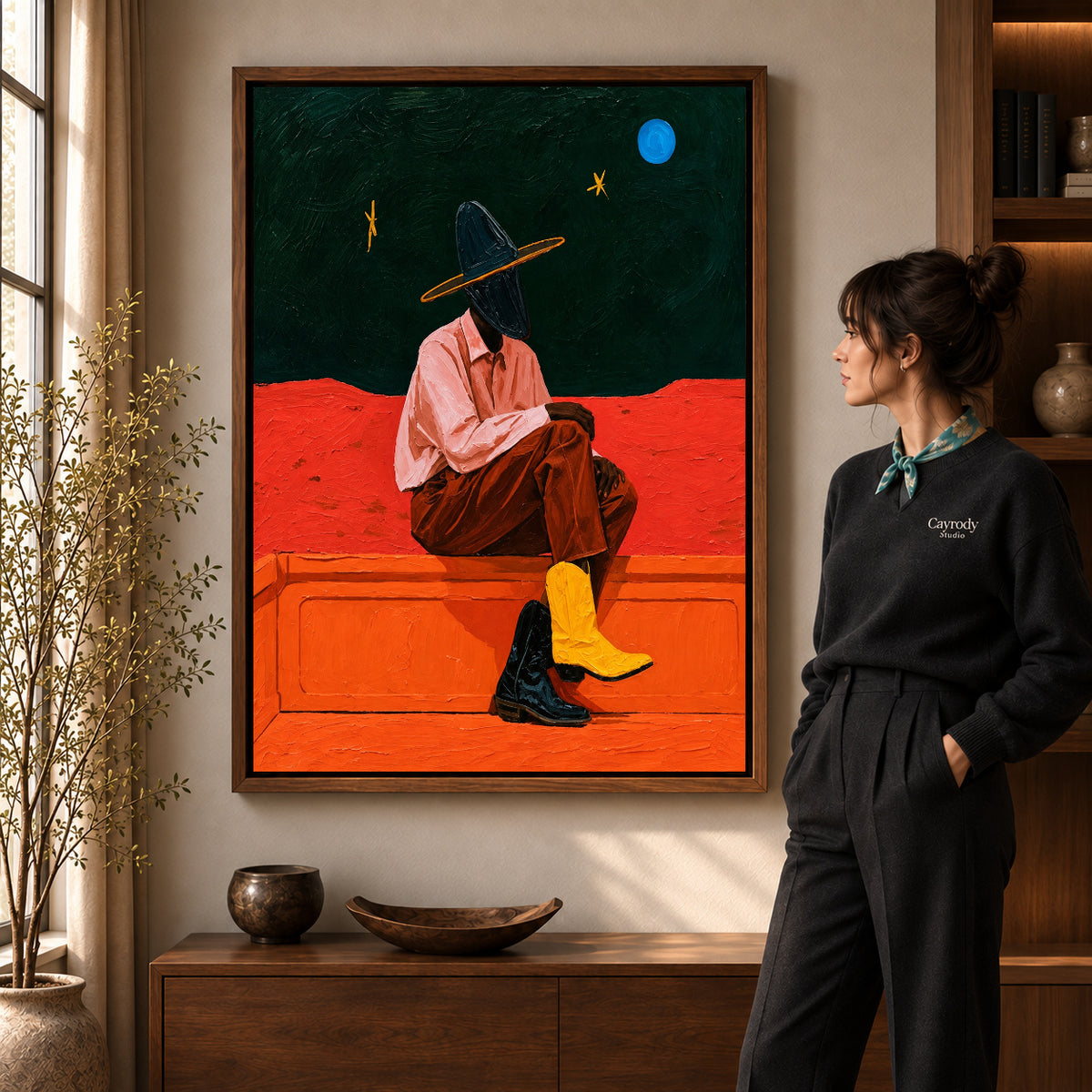 Cowgirl Canvas Wall Art in a walnut frame beside a standing woman and warm wooden furniture.