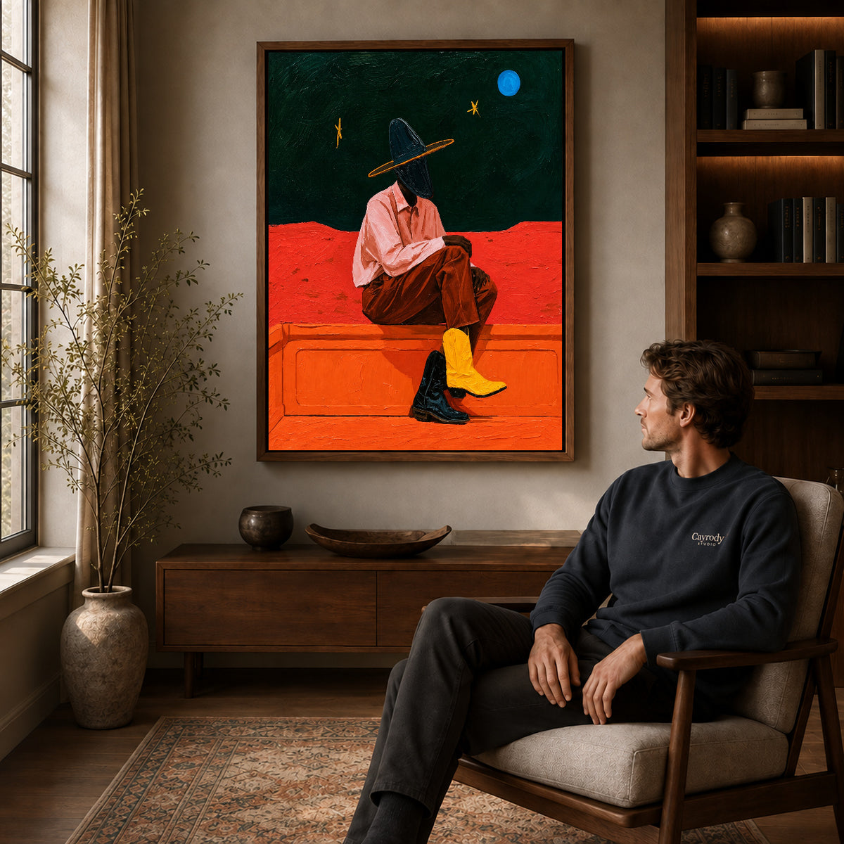 Cowgirl Canvas Wall Art displayed in a walnut frame above wooden furniture beside a seated man.
