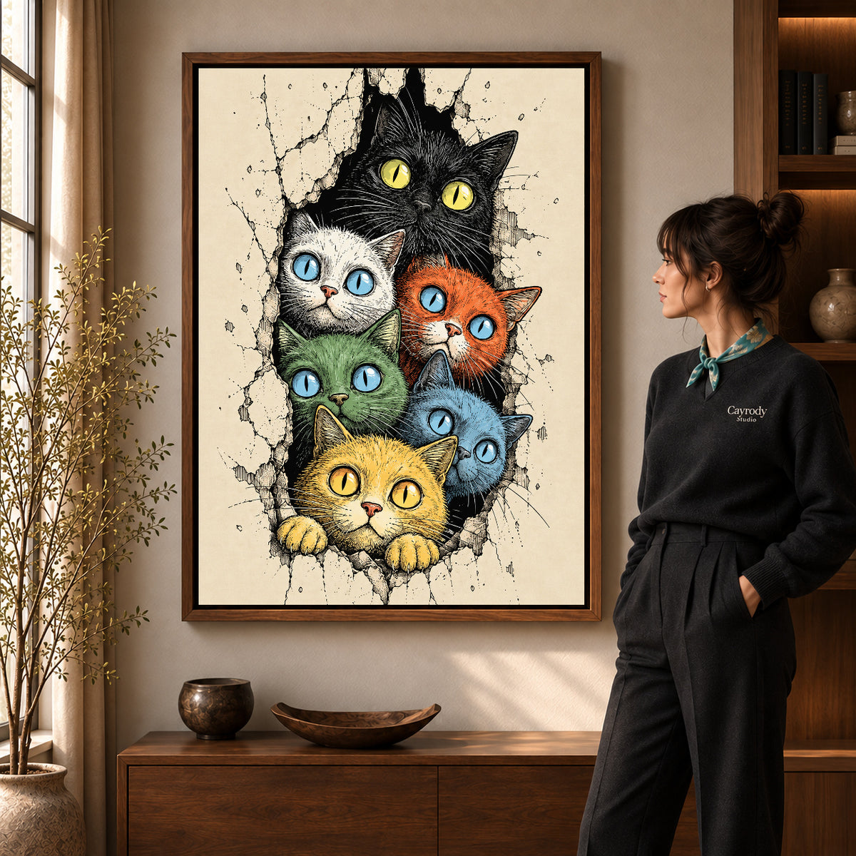 Colorful Cat Canvas Art in a walnut frame beside a standing woman and warm wooden furniture.