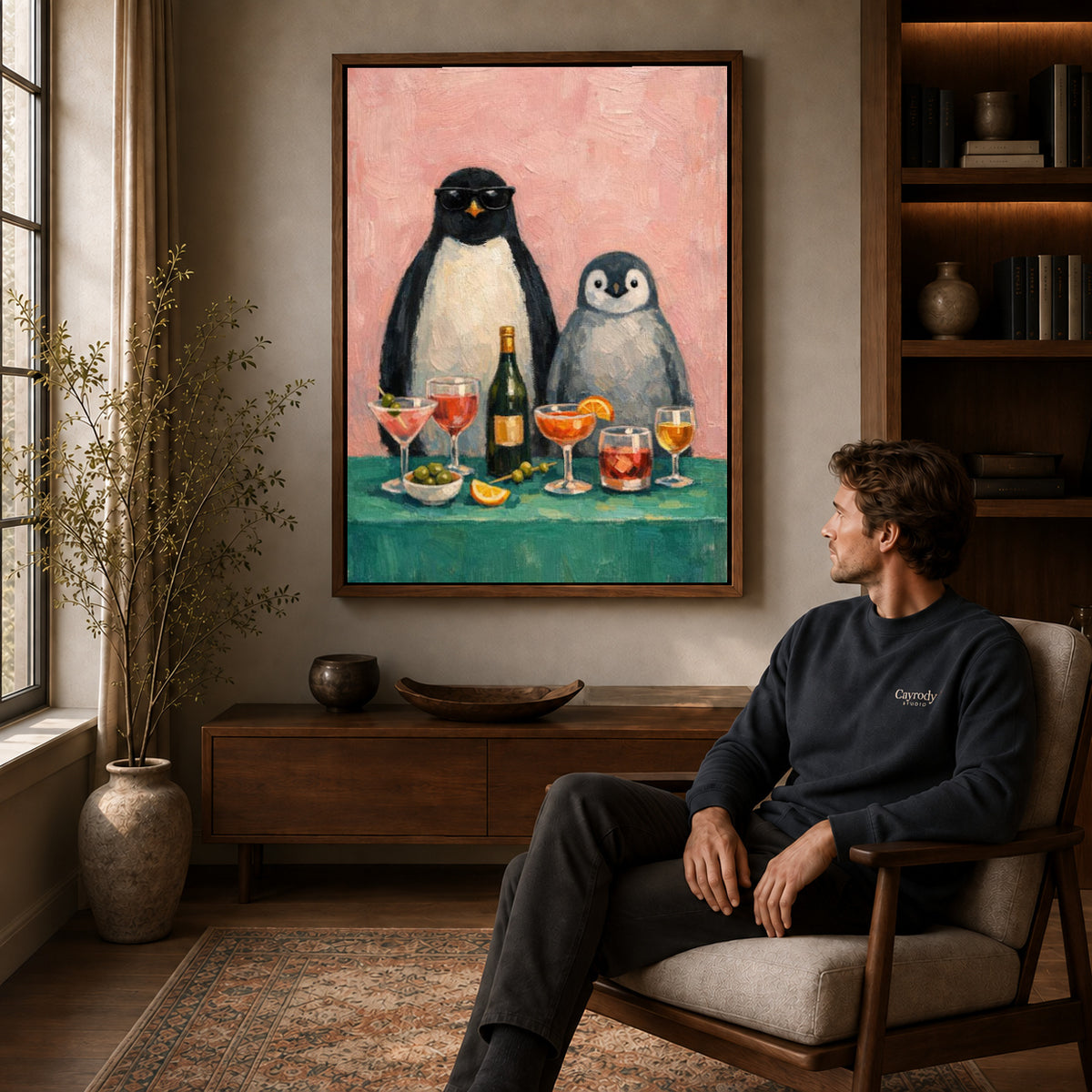 Penguin Canvas Wall Art displayed in a walnut frame above wooden furniture beside a seated man.