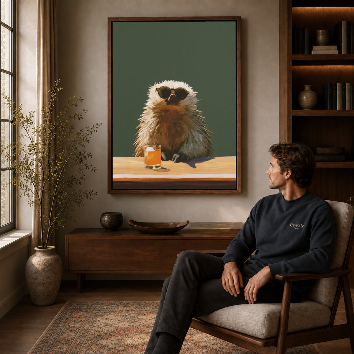 Capybara Canvas Wall Art displayed in a walnut frame above wooden furniture beside a seated man.