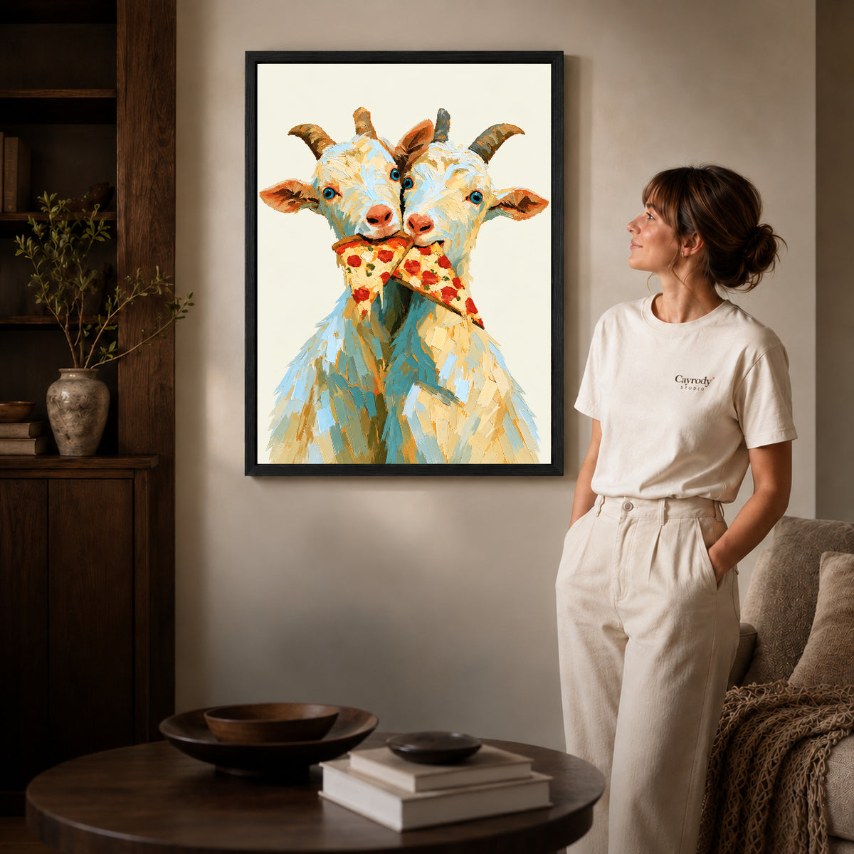 Black framed funny goat canvas art displayed beside a woman with natural light across the wall.