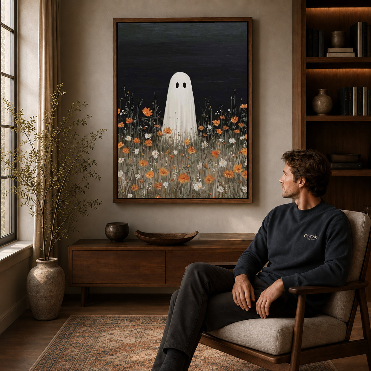 Ghost Canvas Wall Art displayed in a walnut frame above wooden furniture beside a seated man.