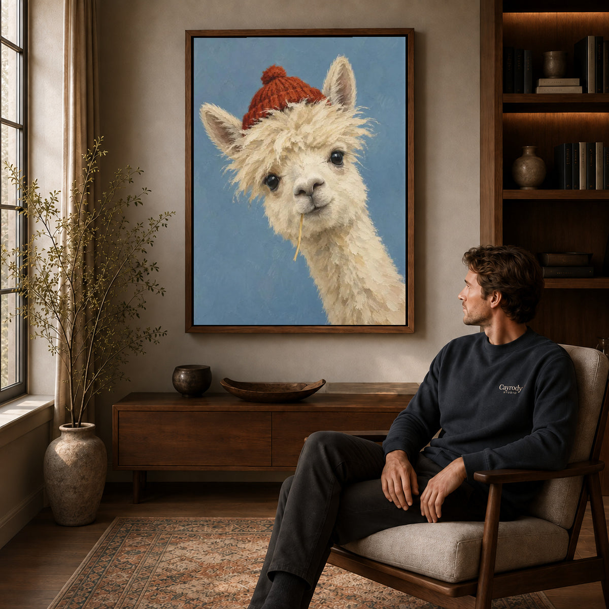 Llama Canvas Wall Art displayed in a walnut frame above wooden furniture beside a seated man.