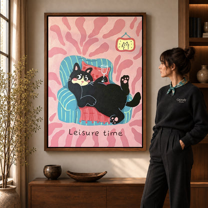 Relaxing Cat Canvas Art in a walnut frame beside a standing woman and warm wooden furniture.
