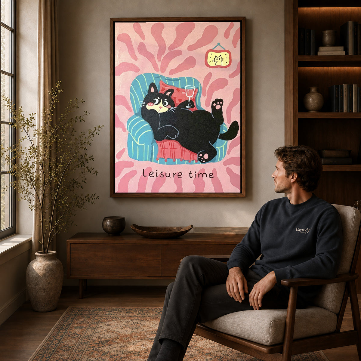 Relaxing Cat Canvas Art displayed in a walnut frame above wooden furniture beside a seated man.