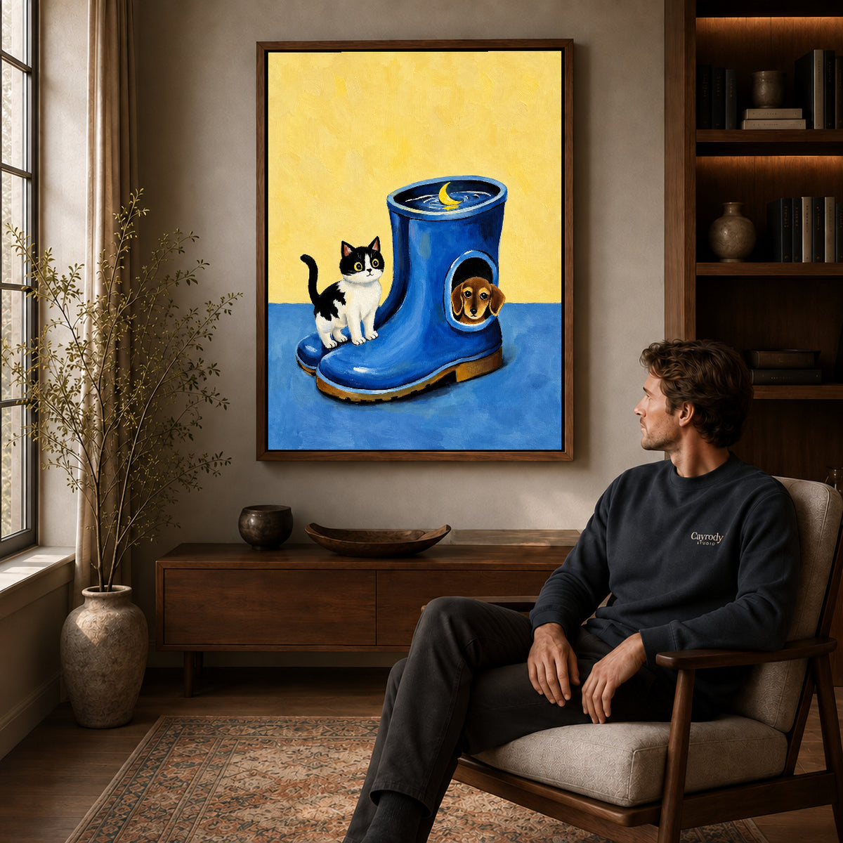 Whimsical Pet Canvas Art displayed in a walnut frame above wooden furniture beside a seated man.