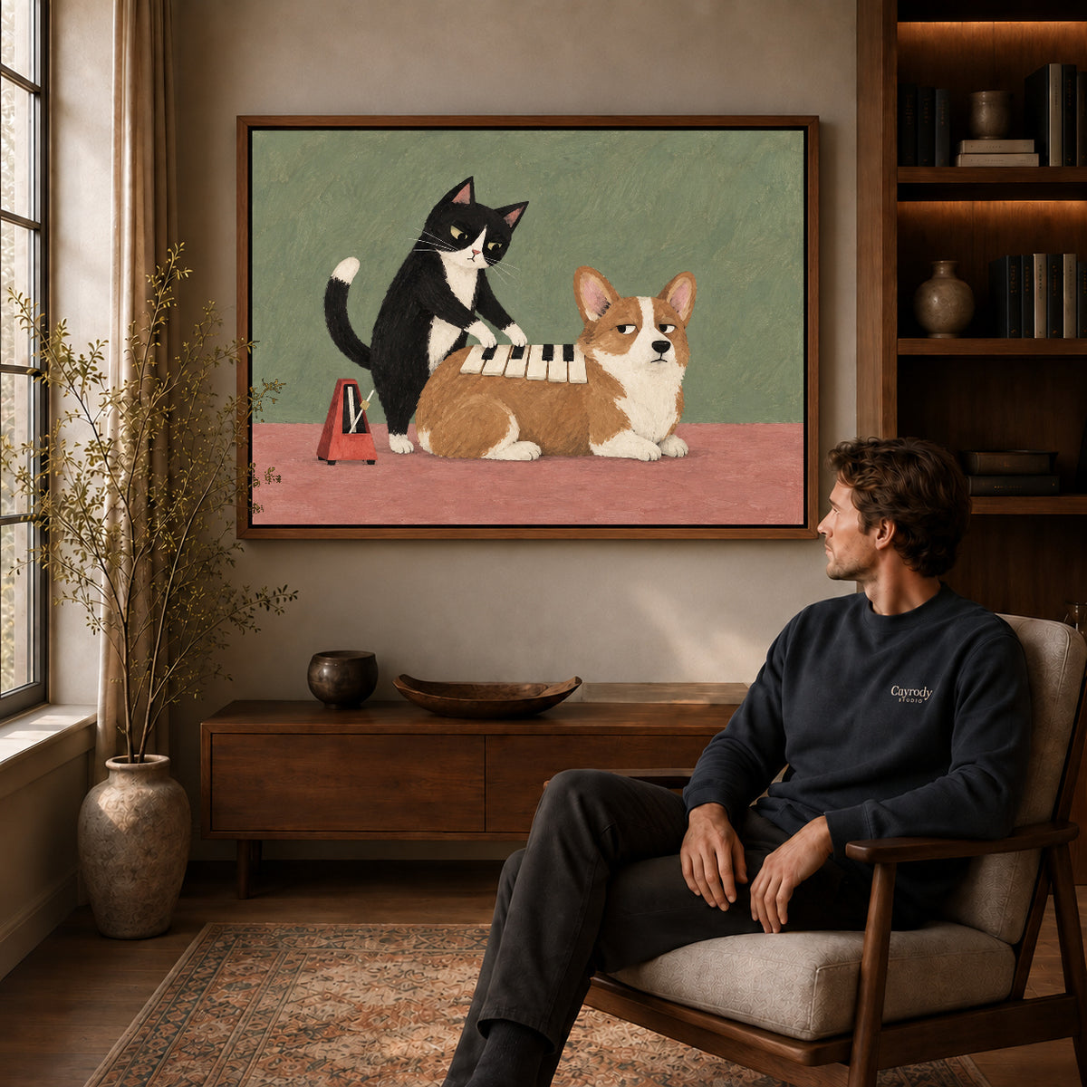 Musical Pet Canvas Art displayed in a walnut frame above wooden furniture beside a seated man.