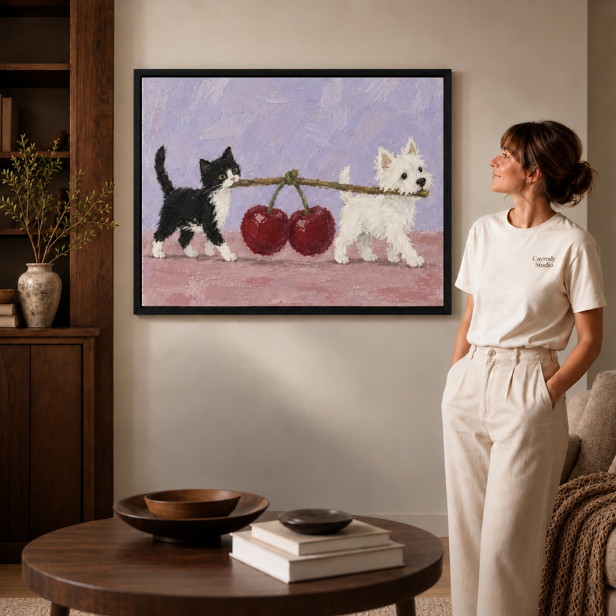 Cat Dog Canvas Art inside a black frame in a softly lit living room with books.