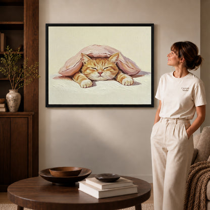 Sleeping Cat Canvas Art inside a black frame in a softly lit living room with books.