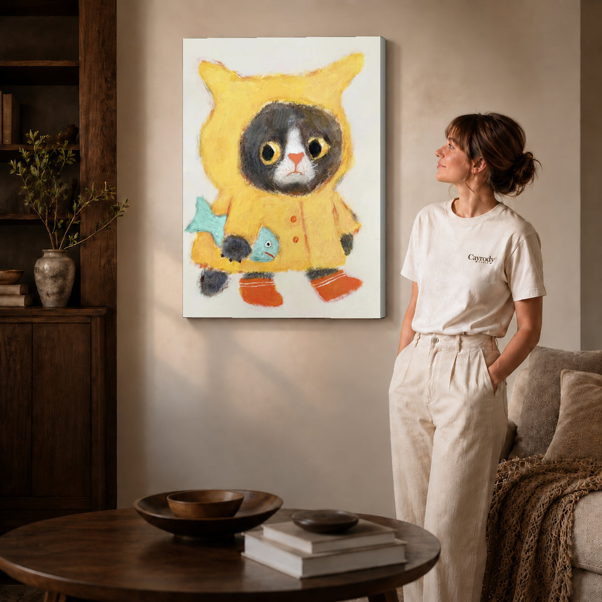 Raincoat Cat Canvas Art on gallery wrapped canvas with visible depth beside a woman in white.