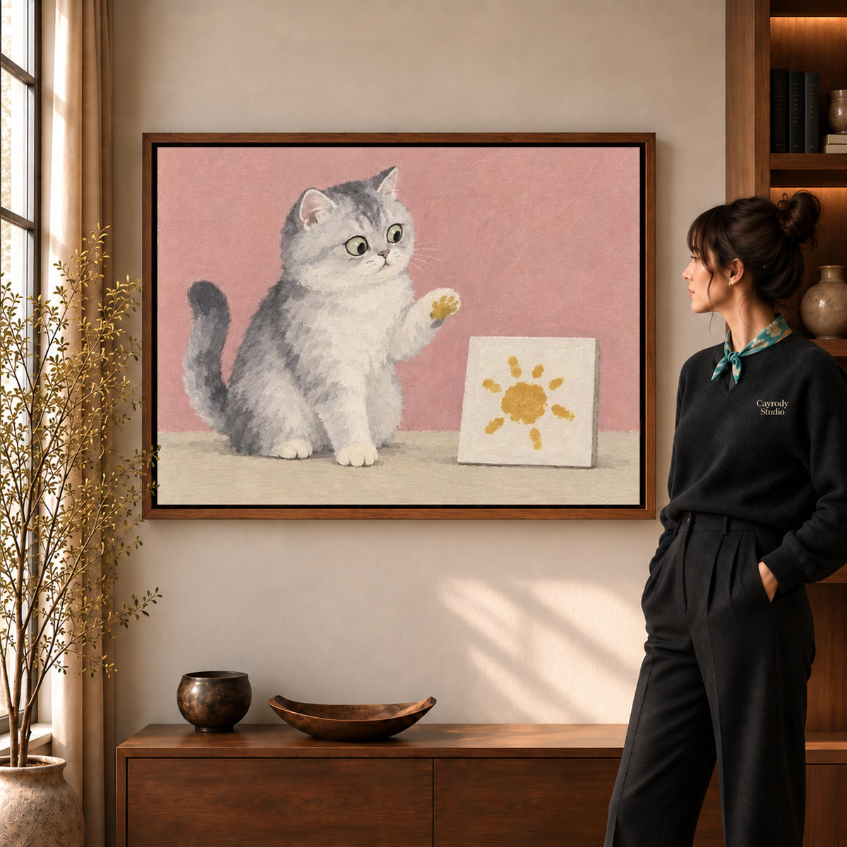 Artist Cat Canvas Art in a walnut frame beside a standing woman and warm wooden furniture.