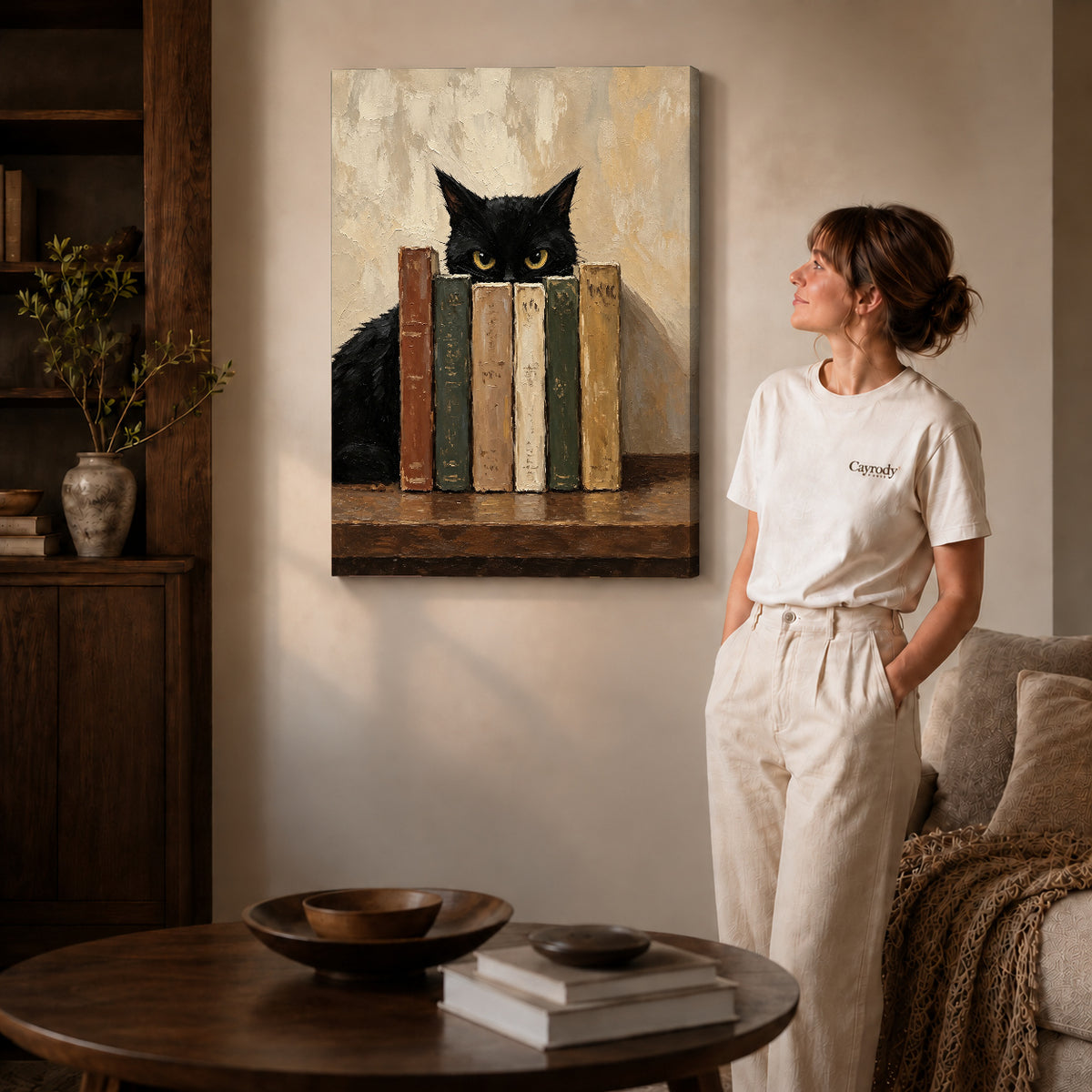 Bookish Cat Canvas Art on gallery wrapped canvas with visible depth beside a woman in white.