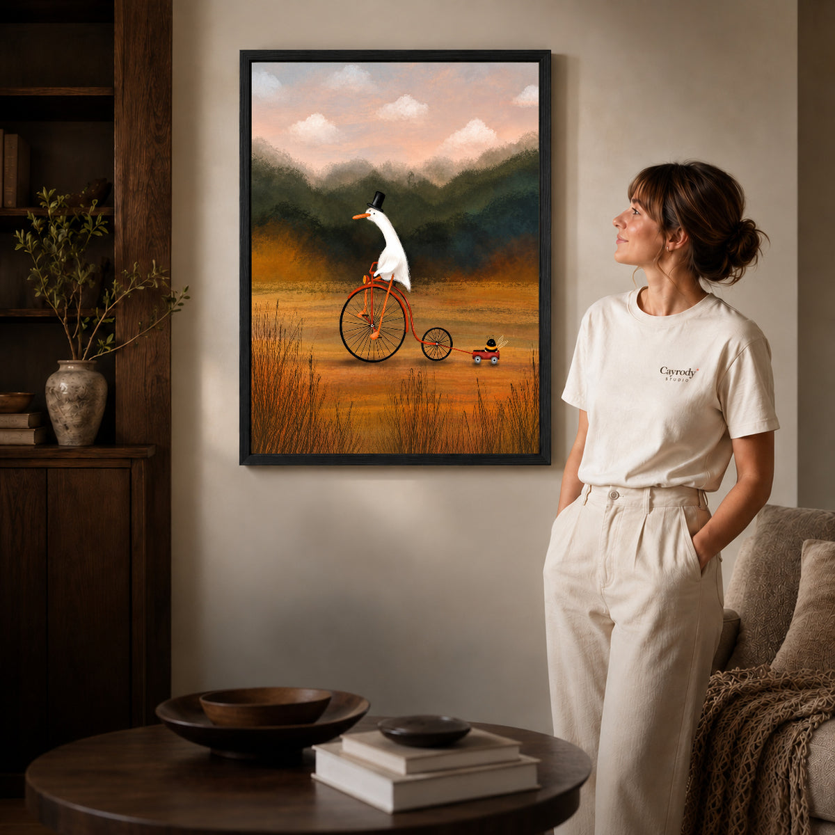Black framed goose canvas wall art displayed beside a woman with natural light across the wall.