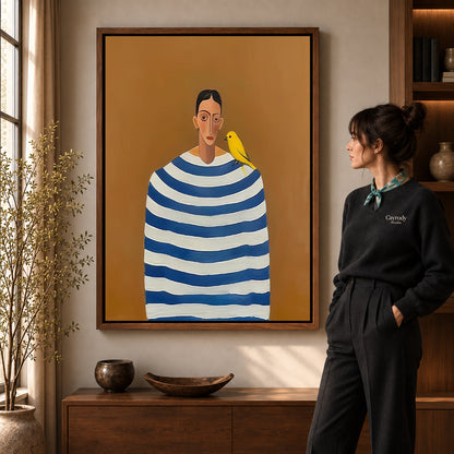 Canary Canvas Wall Art in a walnut frame beside a standing woman and warm wooden furniture.