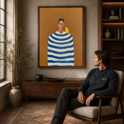 Canary Canvas Wall Art displayed in a walnut frame above wooden furniture beside a seated man.