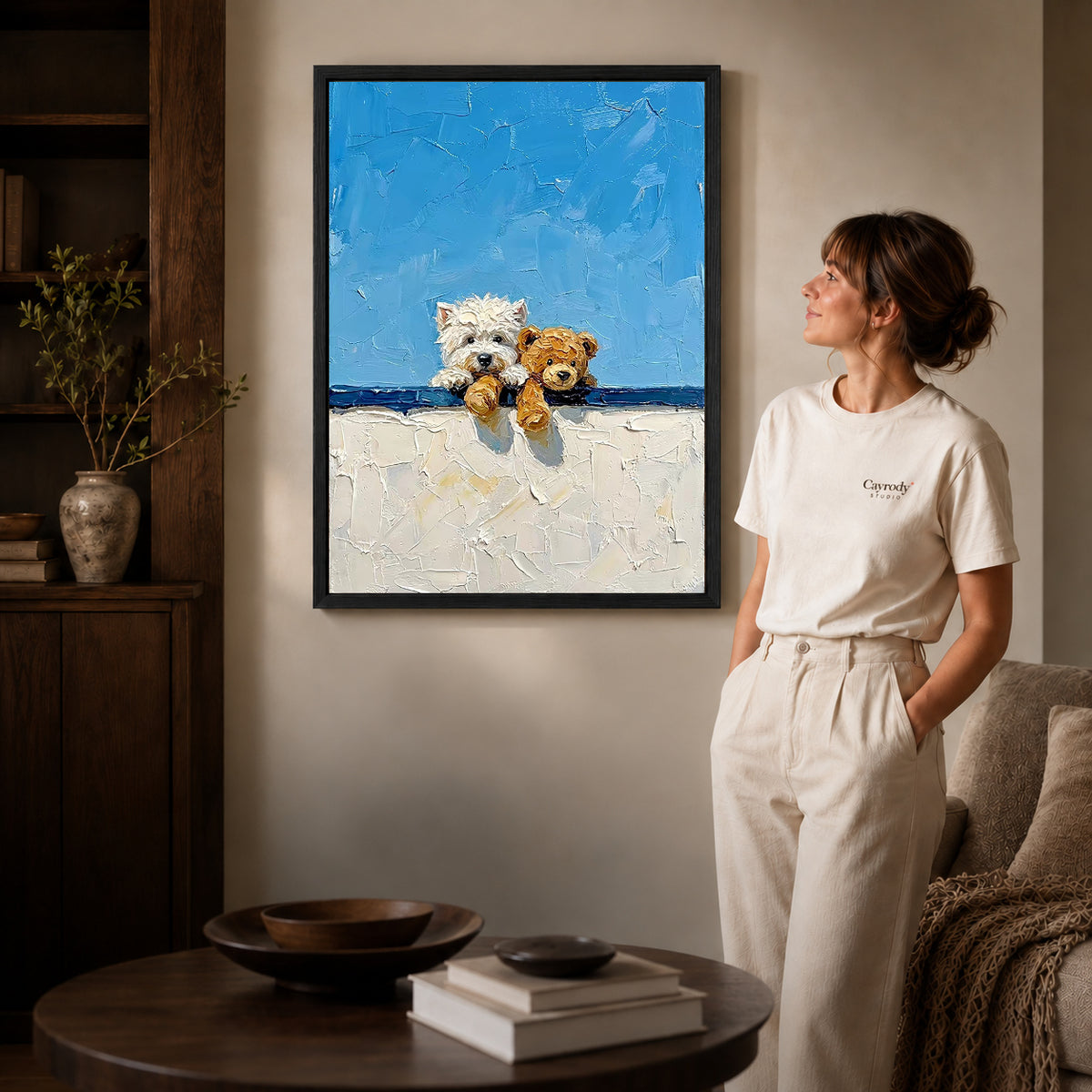 Black framed westie teddy canvas art displayed beside a woman with natural light across the wall.