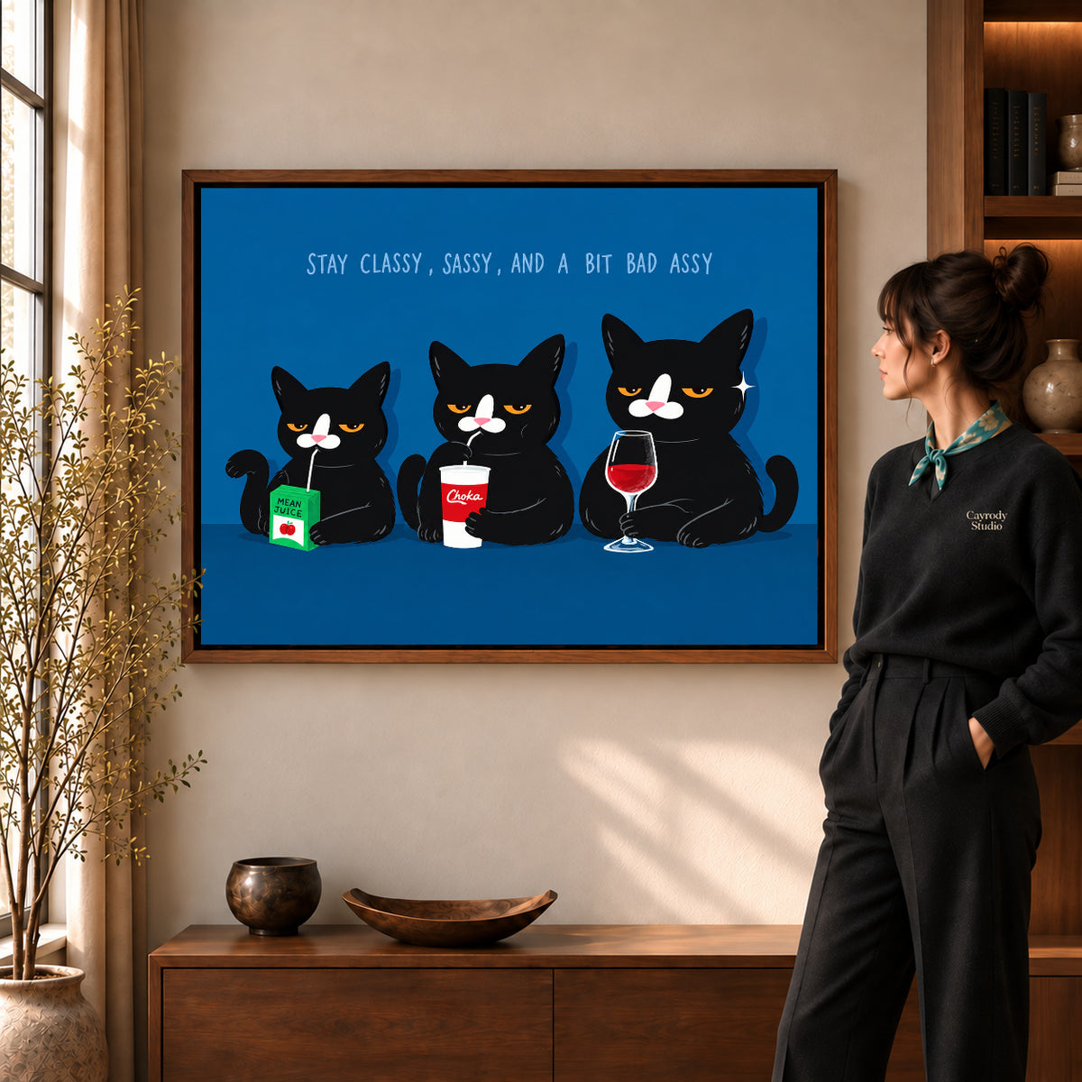 Walnut framed sassy cat trio canvas art with the complete artwork displayed in a warm living room.