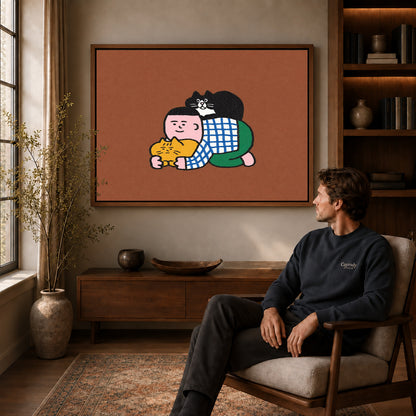 Cuddling Cats Canvas Art displayed in a walnut frame above wooden furniture beside a seated man.