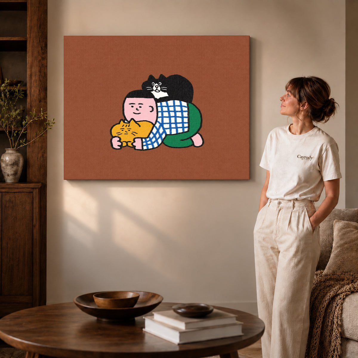 Cuddling Cats Canvas Art on gallery wrapped canvas with visible depth beside a woman in white.