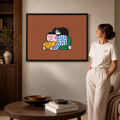 Cuddling Cats Canvas Art inside a black frame in a softly lit living room with books.
