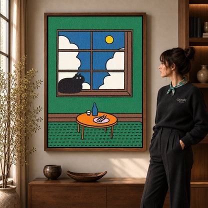 Window Cat Canvas Art in a walnut frame beside a standing woman and warm wooden furniture.