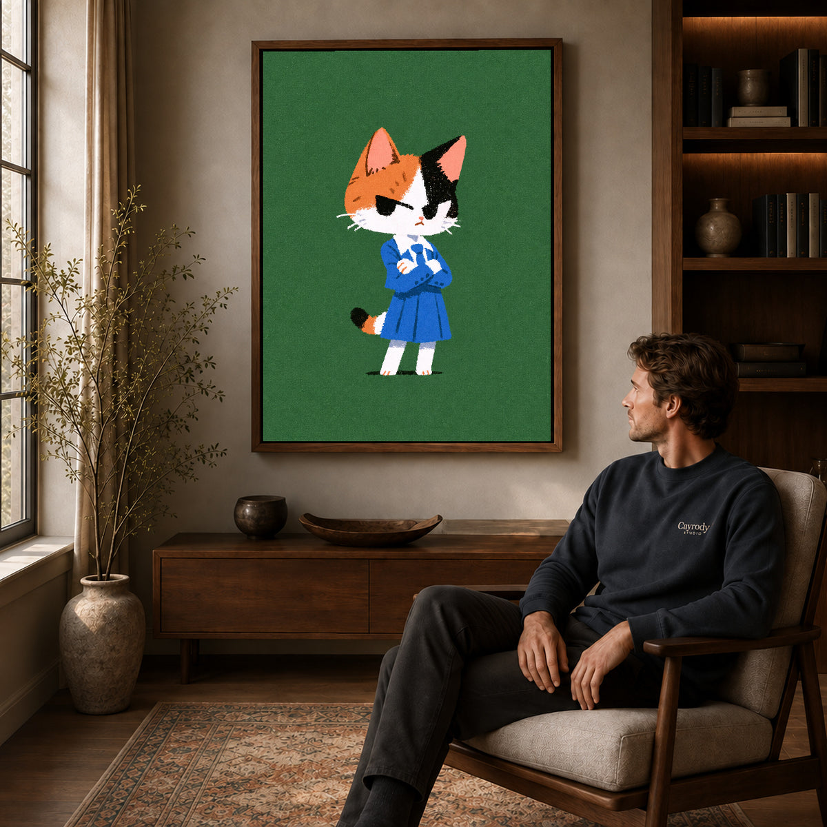 Schoolday Cat Canvas Art displayed in a walnut frame above wooden furniture beside a seated man.