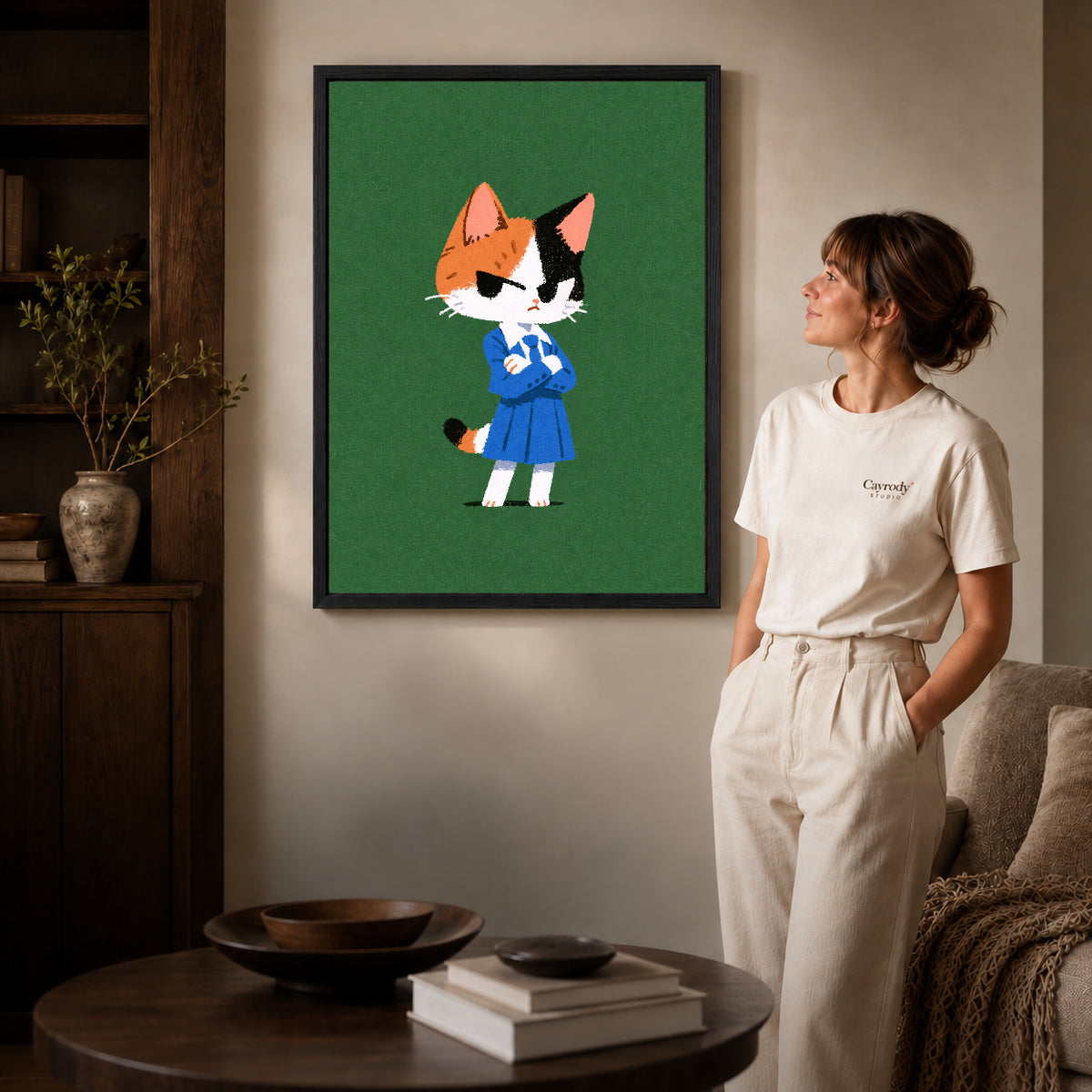 Schoolday Cat Canvas Art inside a black frame in a softly lit living room with books.