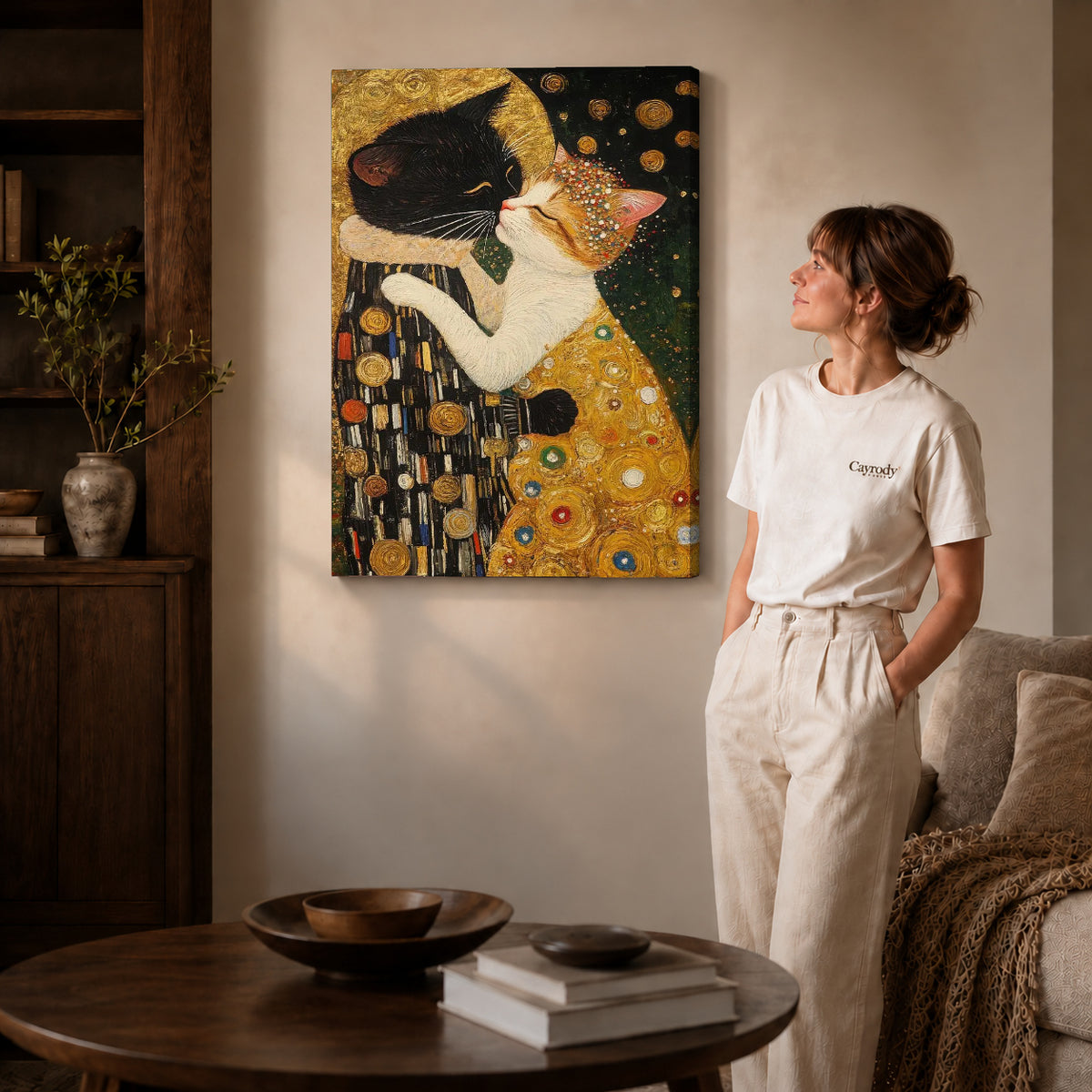 Golden Cat Embrace Canvas Art on gallery wrapped canvas with visible depth beside a woman in white.