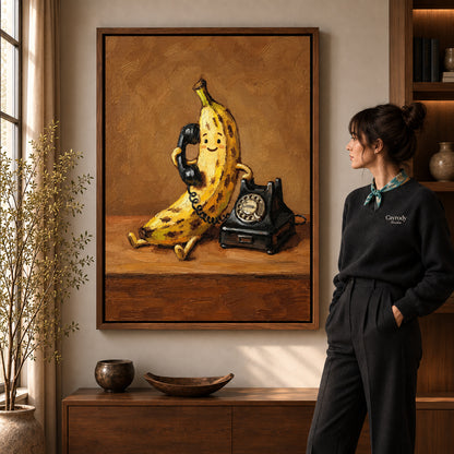 Banana Telephone Canvas Art in a walnut frame beside a standing woman and warm wooden furniture.