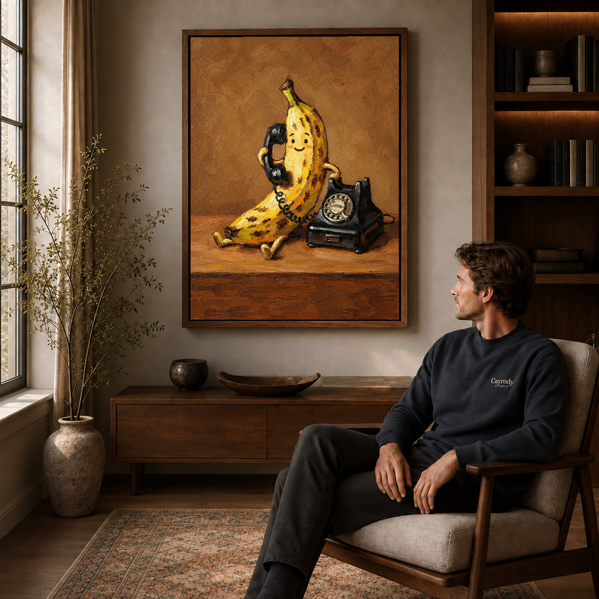 Banana Telephone Canvas Art displayed in a walnut frame above wooden furniture beside a seated man.