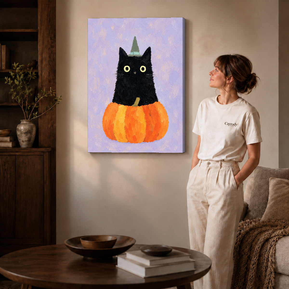 Gallery wrapped pumpkin witch cat canvas art showing dimensional edges and soft shadows in a living room.
