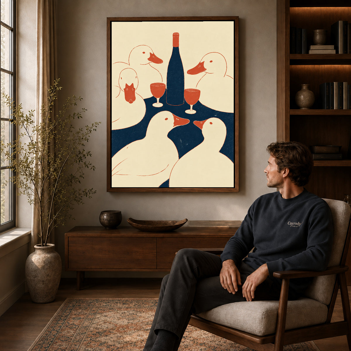 Ducks Toast Canvas Art displayed in a walnut frame above wooden furniture beside a seated man.