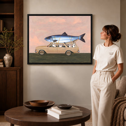 Black framed fishing trip canvas art displayed beside a woman with natural light across the wall.