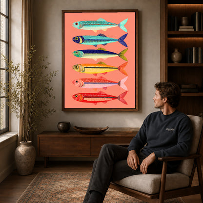 Colorful Sardine Canvas Art displayed in a walnut frame above wooden furniture beside a seated man.