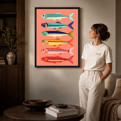Colorful Sardine Canvas Art inside a black frame in a softly lit living room with books.